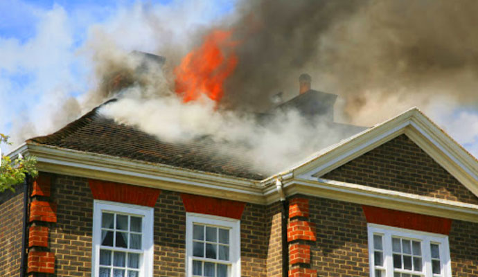 a team performing fire damage restoration service in a fire damaged house