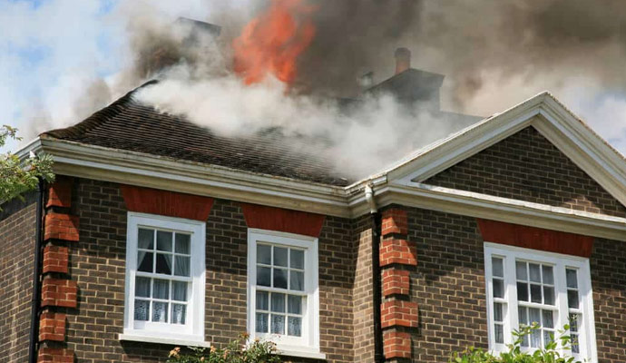 Smoke coming out of a fire damaged house